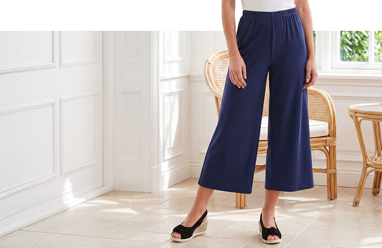 Dame in een donkerblauwe culotte en sandalen