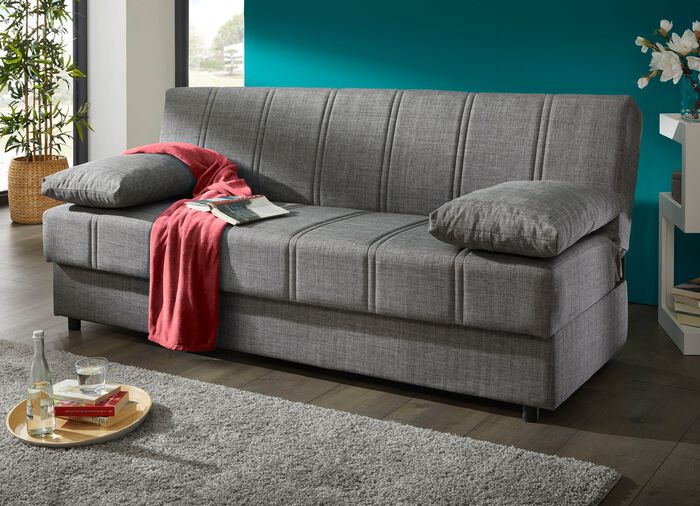 Slaapbank die vrij in de kamer kan worden opgesteld met sierkussens en bedbox 