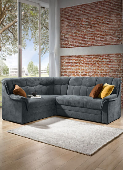 Gestoffeerde hoekbank met slaapfunctie die vrij in de ruimte geplaatst kan worden 